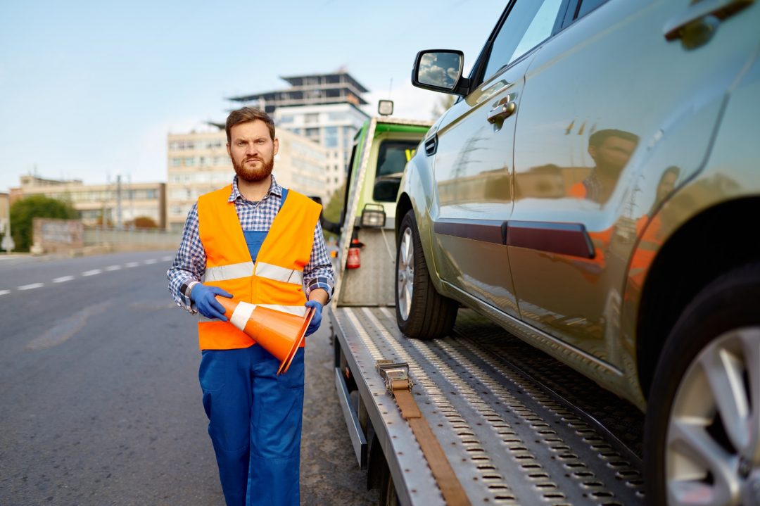 road worker putting traffic cone on roadside Cheapest Towing Near Me Corona, California